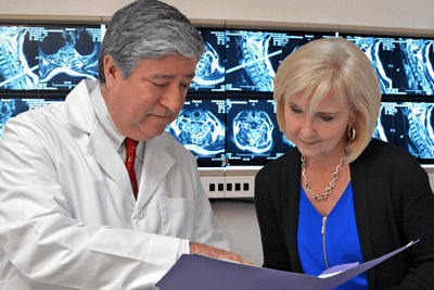 spinal surgeon shows patient MRI